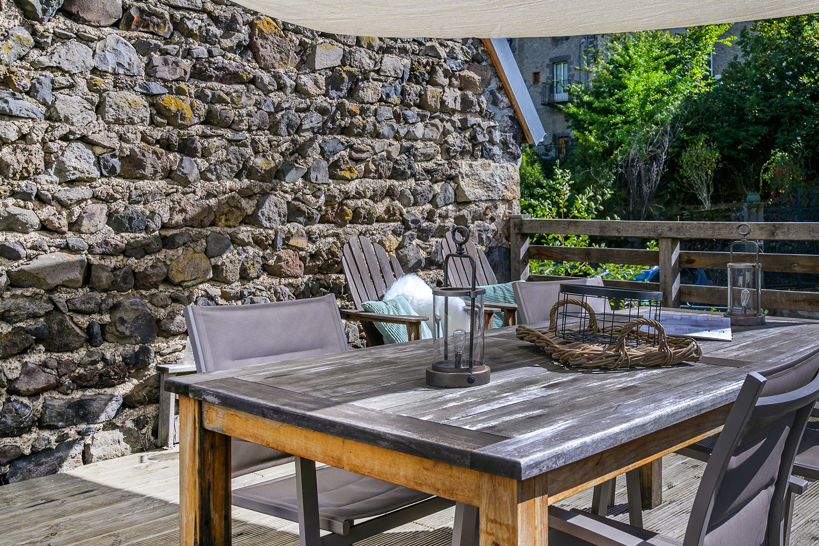 Terrasse maison de vacances LOTT Murol table à manger en tissu solaire.