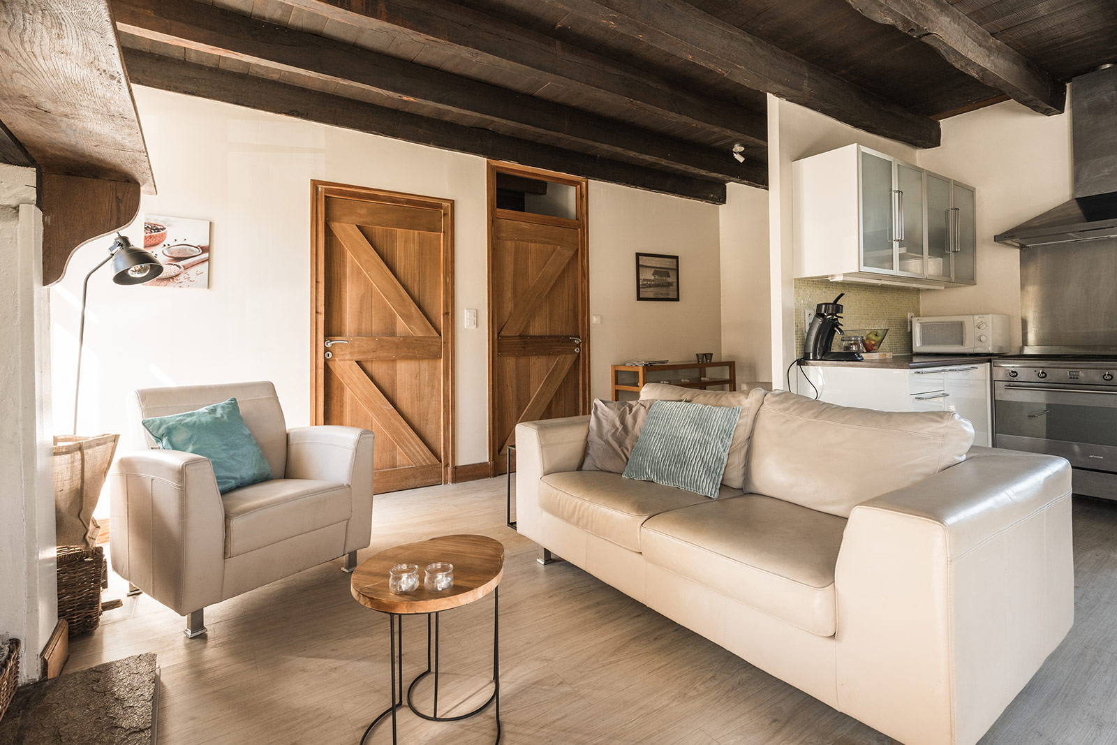 Living room holiday home LOTT La-Bastide sofas and wood stove